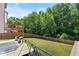 A spacious backyard with a patio, upper deck, swing set, grill, and privacy fence at 4568 Mantova Dr, Buford, GA 30519