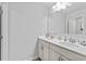 Bright bathroom with double vanity, white cabinets, and a large mirror at 4568 Mantova Dr, Buford, GA 30519