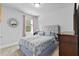 Comfortable bedroom features a queen bed and decorative mirror at 4568 Mantova Dr, Buford, GA 30519