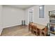 Bright dining area with wood-look flooring and a dining table set, perfect for Gathering meals at 4568 Mantova Dr, Buford, GA 30519