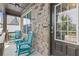 Charming front porch boasts stone accents and cozy blue rocking chairs, providing a welcoming entrance at 4568 Mantova Dr, Buford, GA 30519