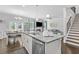 Open concept kitchen with granite countertops, stainless appliances, and an adjacent dining area at 4568 Mantova Dr, Buford, GA 30519