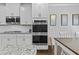 Well-equipped kitchen with stainless appliances, granite counters and bright neutral decor at 4568 Mantova Dr, Buford, GA 30519