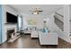 Comfortable living room with a fireplace, ceiling fan, and neutral decor at 4568 Mantova Dr, Buford, GA 30519
