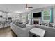 Spacious living area connected to the kitchen with a fireplace and comfortable seating at 4568 Mantova Dr, Buford, GA 30519