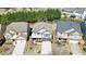 An aerial view features three lovely homes with well-manicured lawns and tree-lined backyards at 5470 Beaver Ridge Dr, Cumming, GA 30040