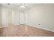 Bedroom with light walls and wood-look flooring, adjoining closet and bathroom at 5470 Beaver Ridge Dr, Cumming, GA 30040