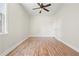Bedroom with ceiling fan, light walls, and wood-look flooring at 5470 Beaver Ridge Dr, Cumming, GA 30040