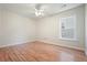 Bedroom with a ceiling fan, wood-look flooring, and a large window at 5470 Beaver Ridge Dr, Cumming, GA 30040