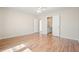 Bedroom featuring light walls and wood-look floors with ensuite bathroom at 5470 Beaver Ridge Dr, Cumming, GA 30040