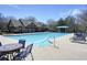 Community pool with ample seating, tables, and a covered area for shade on a sunny day at 5470 Beaver Ridge Dr, Cumming, GA 30040