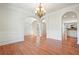 Elegant dining room featuring hardwood floors, decorative columns, and an ornate chandelier at 5470 Beaver Ridge Dr, Cumming, GA 30040
