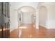 Elegant entryway featuring hardwood floors, archways, decorative columns, and abundant natural light at 5470 Beaver Ridge Dr, Cumming, GA 30040