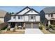 Charming two-story home featuring a gray exterior, stone accents, and a well-manicured front yard at 5470 Beaver Ridge Dr, Cumming, GA 30040