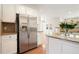 Bright kitchen with stainless steel refrigerator, granite counters, and white cabinets at 5470 Beaver Ridge Dr, Cumming, GA 30040