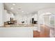 Open kitchen featuring a breakfast bar, granite countertops, stainless steel appliances, and white cabinets at 5470 Beaver Ridge Dr, Cumming, GA 30040