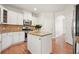 Stylish kitchen with white cabinets, granite countertops, stainless steel appliances, and a center island at 5470 Beaver Ridge Dr, Cumming, GA 30040