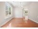 Bright, spacious living room featuring gleaming hardwood floors, a chandelier, and abundant natural light at 5470 Beaver Ridge Dr, Cumming, GA 30040