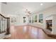 Spacious living room with hardwood floors, stone fireplace, and natural light from large windows at 5470 Beaver Ridge Dr, Cumming, GA 30040