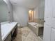 Bathroom featuring double sinks, a large soaking tub, and a separate glass-enclosed shower at 105 Old Hickory Pointe, Mcdonough, GA 30252