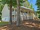 Charming view of the exterior side of the home showcasing a delightful elevated porch at 105 Old Hickory Pointe, Mcdonough, GA 30252