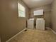 Functional laundry room with washer, dryer, storage cabinet, and a window for natural light at 105 Old Hickory Pointe, Mcdonough, GA 30252