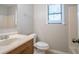 Bathroom featuring a clean sink, toilet, and shower area with a bright window at 5292 Mountain Village Ct, Stone Mountain, GA 30083