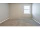 Cozy bedroom with neutral walls, soft carpet, and a bright window at 5292 Mountain Village Ct, Stone Mountain, GA 30083