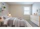 Cozy bedroom featuring a comfy bed, a dresser, and natural light streaming in from a window at 5292 Mountain Village Ct, Stone Mountain, GA 30083