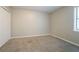 Bright bedroom featuring neutral walls, plush carpet, and a window with natural light at 5292 Mountain Village Ct, Stone Mountain, GA 30083