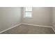 Bedroom with neutral walls, plush carpet, and a bright window at 5292 Mountain Village Ct, Stone Mountain, GA 30083