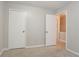 Bedroom with neutral walls, carpet, and doors leading to other rooms at 5292 Mountain Village Ct, Stone Mountain, GA 30083