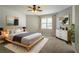 Stylish main bedroom with a comfortable bed, modern decor, and ample natural light through large window at 5292 Mountain Village Ct, Stone Mountain, GA 30083