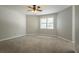 Spacious bedroom with soft carpet, neutral walls, and a ceiling fan at 5292 Mountain Village Ct, Stone Mountain, GA 30083
