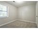 Bright bedroom with carpet, a window, and a ceiling light fixture at 5292 Mountain Village Ct, Stone Mountain, GA 30083
