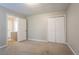 Bedroom with neutral walls, carpet, and a closet, providing a versatile space at 5292 Mountain Village Ct, Stone Mountain, GA 30083