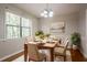 Cozy dining area illuminated by natural light, complemented by modern light fixture and neutral tones at 5292 Mountain Village Ct, Stone Mountain, GA 30083