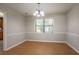 Bright dining room boasts wood floors, chair rail detail, and a chandelier at 5292 Mountain Village Ct, Stone Mountain, GA 30083