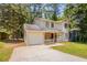 Well-kept two-story home with stone facade details, a cozy porch, and attached single car garage at 5292 Mountain Village Ct, Stone Mountain, GA 30083