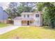 Charming two-story home featuring stone accents, a covered front porch, and a single-car garage at 5292 Mountain Village Ct, Stone Mountain, GA 30083