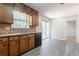Functional kitchen with wood cabinets, stainless steel dishwasher, and deck access at 5292 Mountain Village Ct, Stone Mountain, GA 30083