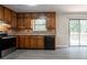 Bright kitchen features updated appliances, wood cabinets, and sliding door access to the deck at 5292 Mountain Village Ct, Stone Mountain, GA 30083