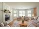 Bright living room featuring a stone fireplace, hardwood floors, and natural light from large windows at 5292 Mountain Village Ct, Stone Mountain, GA 30083