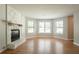 Inviting living room features a stone fireplace and large windows, filling the space with natural light at 5292 Mountain Village Ct, Stone Mountain, GA 30083