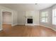 Spacious living room with a fireplace, hardwood floors, and abundant natural light at 5292 Mountain Village Ct, Stone Mountain, GA 30083