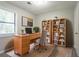 Bright home office featuring sleek desk, built-in bookshelves, and natural light at 5292 Mountain Village Ct, Stone Mountain, GA 30083