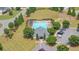 Aerial view of community pool area with lounge chairs and parking at 6370 Stillwood Ln, Cumming, GA 30041