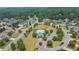 Community pool and clubhouse amidst lush landscaping and surrounding residences at 6370 Stillwood Ln, Cumming, GA 30041