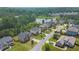 Scenic aerial view of a charming residential neighborhood with lush landscaping and a tranquil lake in the background at 6370 Stillwood Ln, Cumming, GA 30041