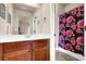 Bathroom featuring a vanity and walk-in shower with a floral print curtain at 6370 Stillwood Ln, Cumming, GA 30041